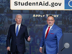 FILE - President Joe Biden answers questions with Education Secretary Miguel Cardona as they leave an event about the student debt relief portal beta test in the South Court Auditorium on the White House complex in Washington, Oct. 17, 2022. The Biden administration is no longer accepting applications for student loan forgiveness after a second federal court shut down the program. (AP Photo/Susan Walsh, File)