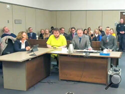 In this image taken from El Paso County District Court video, Anderson Lee Aldrich, 22, center, sits during a court appearance in Colorado Springs, Colo., Tuesday, Dec. Nov. 6, 2022. Aldrich, the suspect accused of entering a Colorado gay nightclub clad in body armor and opening fire with an AR-15-style rifle, killing five people and wounding 17 others, was charged by prosecutors Tuesday with 305 criminal counts including hate crimes and murder. (El Paso County District Court via AP)