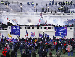 FILE - Violent insurrectionists, loyal to President Donald Trump, storm the Capitol in Washington on Jan. 6, 2021. Ronald Sandlin, a Tennessee man who authorities say came to Washington ahead of the Jan. 6, 2021, riot ready for violence in a car full of weapons and assaulted officers who were trying to defend the Capitol, has been sentenced to more than five years behind bars. (AP Photo/John Minchillo, File)