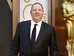 FILE - Movie mogul Harvey Weinstein arrives at the Oscars at the Dolby Theatre in Los Angeles, March 2, 2014. On Monday, Dec. 19, 2022, Weinstein was found guilty of rape at a Los Angeles trial in another #MeToo moment of reckoning, five years after he became a magnet for the movement. (Photo by Jordan Strauss/Invision/AP, File)