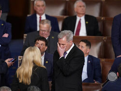 Rep. Kevin McCarthy, R-Calif., talks with Rep. Marjorie Taylor Greene, R-Ga., at the beginning of an evening session after six failed votes to elect a speaker and convene the 118th Congress in Washington, Wednesday, Jan. 4, 2023. (AP Photo/Alex Brandon)