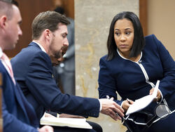 FILE - Fulton County District Attorney Fani Willis, right, talks with a member of her team during proceedings to seat a special purpose grand jury in Fulton County, Georgia, on May 2, 2022, to look into the actions of former President Donald Trump and his supporters who tried to overturn the results of the 2020 election. The hearing took place in Atlanta. (AP Photo/Ben Gray, File)