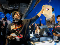 Roland Conner, left, holds the first legal purchase of cannabis, bought from his son Darius, right, from their "pop up" dispensary location of their business Smacked , Tuesday, Jan. 24, 2023, in New York. The store is the first Conditional Adult-Use Retail Dispensary (CAURD) opening since the legalization of cannabis that is run by businesspeople who had been criminalized by cannabis prohibition. (AP Photo/John Minchillo)