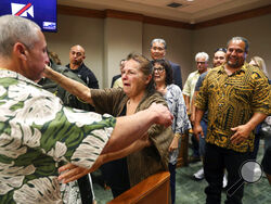 Albert "Ian" Schweitzer, left, hugs his mother, Linda, moments after a judge ordered him released from prison, in Hilo, Hawaii, Tuesday, Jan. 24, 2023. The judge's ruling came immediately after Schweitzer's attorneys presented new evidence and argued that Schweitzer didn’t commit the crimes he was convicted of and spent more than 20 years locked up for: the 1991 murder, kidnapping and sexual assault of a woman visiting Hawaii. (Marco Garcia/The Innocence Project via AP Images)