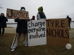 A group of demonstrators gather at dusk in Shelby Farms Park on Monday, Jan. 30, 2023, in Memphis, Tenn., in response to the death of Tyre Nichols, who died after being beaten by Memphis police officers. Nichols, who had a hobby in photography, frequented the park to photograph sunsets. (AP Photo/Gerald Herbert)