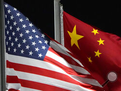 FILE - The American and Chinese flags wave at Genting Snow Park ahead of the 2022 Winter Olympics, Feb. 2, 2022, in Zhangjiakou, China. Secretary of State Antony Blinken has postponed a planned high-stakes weekend diplomatic trip to China as the Biden administration weighs a broader response to the discovery of a high-altitude Chinese balloon flying over sensitive sites in the western United States, a U.S. official said Friday. (AP Photo/Kiichiro Sato, File)