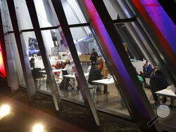 People are seen inside the Broad Art Museum near Berkey Hall on the campus of Michigan State University as they shelter in place, late Monday, Feb. 13, 2023, in East Lansing, Mich. (AP Photo/Al Goldis)