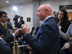 FILE - Sen. Mark Kelly, D-Ariz., speaks with reporters following a classified briefing on China, at the Capitol in Washington, Feb. 15, 2023. Senators are investigating how the suspected Chinese surveillance balloon was allowed to pass over crucial missile sites. Kelly is a former astronaut. He wants to require weather balloons to carry a radar transponder. (AP Photo/J. Scott Applewhite, File)