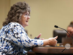 Kathy Wilmot, a member of the University of Nebraska Board of Regents, testifies against LB20, a bill to provide restoration of voting rights upon completion of a felony sentence or probation for a felony, during a hearing before the Government, Military and Veterans Affairs committee on Wednesday, Feb. 22, 2023, at the Nebraska state Capitol in Lincoln, Neb. Wilcot stressed she was speaking as an individual and not on behalf of the university. (AP Photo/Rebecca S. Gratz)
