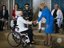 First lady Jill Biden congratulates Malaysian Senator Datuk Ras Adiba Radzi during the 17th annual International Women of Courage (IWOC) Award ceremony in the East Room of the White House, in Washington, to commemorate International Women's Day, Wednesday, March 8, 2023. (AP Photo/Manuel Balce Ceneta)