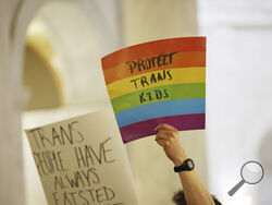 Protestors hold signs during a rally opposing HB2007 at the state capitol in Charleston, W.Va., on March 9, 2023. HB2007 would ban health care for trans children in the state. (AP Photo/Chris Jackson)