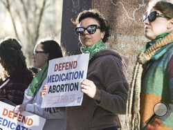 Lindsay London holds protest sign in front of federal court building in support of access to abortion medication outside the Federal Courthouse on Wednesday, March 15, 2023 in Amarillo, Texas. A conservative federal judge heard arguments Wednesday from a Christian group seeking to overturn the Food and Drug Administration’s more than 2-decade-old approval of an abortion medication, in a case that could threaten the most common form of abortion in the U.S. (AP Photo/David Erickson)