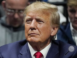 FILE - Former President Donald J. Trump watches the NCAA Wrestling Championships, Saturday, March 18, 2023, in Tulsa, Okla. Trump’s calls for protests ahead of his anticipated indictment in New York have generated mostly muted reactions from supporters, with even some of his most ardent loyalists dismissing the idea as a waste of time or a law enforcement trap. (AP Photo/Sue Ogrocki, File)