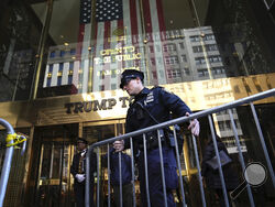 A police officer places a barricade in front of Trump Tower, on Tuesday, March 21, 2023, in New York. (AP Photo/Bryan Woolston)