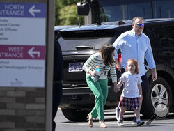 Adults walk with a child at a reunification center at the Woodmont Baptist Church after a shooting at The Covenant School, Monday, March 27, 2023, in Nashville, Tenn. (AP Photo/John Bazemore)