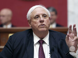 FILE - West Virginia Gov. Jim Justice speaks in the House Chambers at the state capitol in Charleston, W.Va., on Jan. 11, 2023. Gov. Justice on Wednesday, March 29, 2023, signed a bill banning gender-affirming care for minors, joining at least 10 other states that have enacted laws restricting or outlawing medically supported treatments for transgender youth. (AP Photo/Chris Jackson, File)