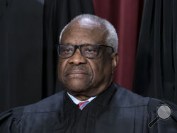 FILE - Associate Justice Clarence Thomas joins other members of the Supreme Court as they pose for a new group portrait, at the Supreme Court building in Washington, Oct. 7, 2022. Thomas has for more than two decades accepted luxury trips nearly every year from Republican megadonor Harlan Crow without reporting them on financial disclosure forms, ProPublica reports. (AP Photo/J. Scott Applewhite, File)