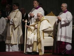 Pope Francis holds a Paschal candle as he presides over a Easter vigil ceremony in St. Peter's Basilica at the Vatican, Saturday, April 8, 2023. (AP Photo/ (AP Photo/Gregorio Borgia)