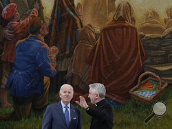 President Joe Biden tours the Knock Shrine with Father Richard Gibbons, parish priest and rector of Knock Shrine, in Knock, Ireland, Friday, April 14, 2023. (AP Photo/Patrick Semansky)