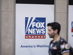  FILE - A person walks past the Fox News Headquarters in New York, April. 12, 2023. Dominion Voting Systems' defamation lawsuit against Fox News for airing bogus allegations of fraud in the 2020 election is set to begin trial on Monday, April 17, 2023, in Delaware. (AP Photo/Yuki Iwamura, File)