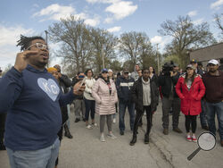 Thea Davis, pastor at Restore Community Church, left, addresses a crowd of protestors before a march Sunday, April 16, 2023, in Kansas City, Missouri, to bring attention to the shooting of Ralph Yarl, 16, who was shot when he went to the wrong Kansas City house to pick up his brothers. (Susan Pfannmuller/The Kansas City Star via AP)