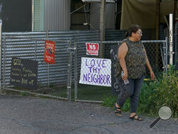 Alondra Ruiz Vazquez walks outside her home at the Periwinkle Mobile Home Park, Thursday, April 11, 2023, in Phoenix. Residents of the park are facing an eviction deadline of May 28 due to a private university's plan to redevelop the land for student housing. (AP Photo/Matt York)