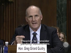 In this image from video provided by the U.S. Senate, Judge Greg Guidry speaks during a hearing for district court nominees held by the Senate Committee on the Judiciary in Washington, on Wednesday, Feb. 13, 2019. Guidry donated tens of thousands of dollars to New Orleans’ Roman Catholic archdiocese and consistently ruled in favor of the church amid a contentious bankruptcy involving nearly 500 clergy sex abuse victims, The Associated Press found, an apparent conflict that could throw the case into disarray
