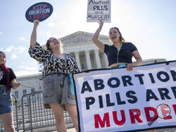 Staff with the group, Progressive Anti-Abortion Uprising, Kristin Turner, of San Francisco, left, Lauren Handy, of Washington, and Caroline Smith, of Washington, right, demonstrate against abortion pills outside of the Supreme Court, Friday, April 21, 2023, ahead of an abortion pill decision by the court in Washington. (AP Photo/Jacquelyn Martin)