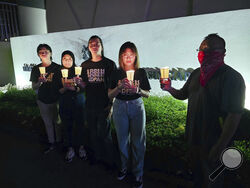 In this image taken and provided by Anti-Death Penalty Asia Network, members of Anti-Death Penalty Asia Network (ADPAN) hold candle outside Singapore Embassy in Kuala Lumpur, Malaysia Wednesday, April 26, 2023. Singapore on Wednesday executed a man accused of coordinating a cannabis delivery, despite pleas for clemency from his family and protests from activists that he was convicted on weak evidence. (Anti-Death Penalty Asia Network (ADPAN) via AP)