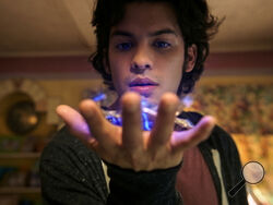 This image released by Warner Bros. Pictures shows Xolo Maridueña in a scene from "Blue Beetle." (Warner Bros. Pictures via AP)