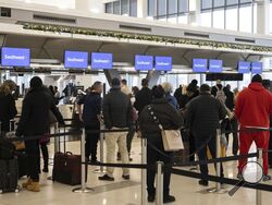 FILE - Hundreds of Southwest Airlines checked bags are piled together at baggage claim at Midway International Airport as Southwest continues to cancel thousands of flights across the country on Dec. 28, 2022, in Chicago. The Biden administration is working on new regulations that would require airlines to compensate passengers and cover their meals and hotel rooms if they are stranded for reasons within the airline's control. The White House said President Joe Biden and Transportation Secretary Pete Buttig