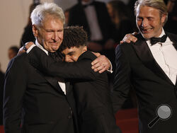 Harrison Ford, left, Ethann Isidore and Mads Mikkelsen pose for photographers upon departure from the premiere of the film 'Indiana Jones and the Dial of Destiny' at the 76th international film festival, Cannes, southern France, Thursday, May 18, 2023. (Photo by Joel C Ryan/Invision/AP)