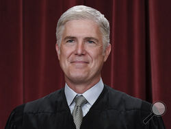 FILE - Associate Justice Neil Gorsuch joins other members of the Supreme Court as they pose for a new group portrait, at the Supreme Court building in Washington, Friday, Oct. 7, 2022. Gorsuch called emergency measures taken during the COVID-19 crisis that killed more than 1 million Americans perhaps “the greatest intrusions on civil liberties in the peacetime history of this country.” The 55-year-old conservative justice pointed to orders closing schools, restricting church services, mandating vaccines and