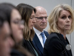 Dr. Caitlin Bernard, left, sits between attorneys John Hoover and Alice Morical on Thursday, May 25, 2023, before a hearing in front of the state medical board at the Indiana Government South building in downtown Indianapolis. Bernard is appearing before the board for the final hearing in a complaint filed by Attorney General Todd Rokita saying she violated patient privacy laws and reporting laws. (Mykal McEldowney/The Indianapolis Star via AP)