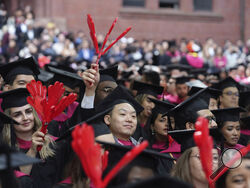 File - Harvard University students celebrate their graduate degrees in public health during Harvard commencement ceremonies, Thursday, May 25, 2023, in Cambridge, Mass. A pause on student loan payments that's been in place since the start of the COVID pandemic will end late this summer if Congress approves a debt ceiling and budget deal negotiated by House Speaker Kevin McCarthy and President Joe Biden. (AP Photo/Steven Senne, File)