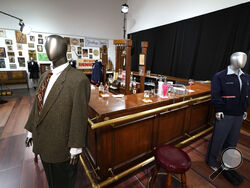 FILE - The bar used on the set of the television series "Cheers" and some costumes worn by actors on the sitcom are displayed, April 27, 2023, in Irving, Texas. The bar from the television series “Cheers” sold for $675,000 at auction over the weekend, garnering the highest bid among the nearly 1,000 props, costumes and sets from classic TV shows offered up from a collection amassed by one man over more than three decades. Heritage Auctions said that the items sold during its three-day event that wrapped up 