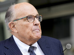 FILE - Rudy Giuliani speaks with reporters as he departs the federal courthouse, May 19, 2023, in Washington. Giuliani, the former mayor of New York City, says a woman’s lawsuit alleging he coerced her into sex and owes her nearly $2 million in unpaid wages is “a large stretch of the imagination” filled with exaggerations and salacious details “to create a media frenzy.” (AP Photo/Patrick Semansky, File)
