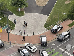 Police vehicles arrive at the scene of a shooting Tuesday, June 6, 2023, in Richmond, Va. Authorities in Richmond say seven people were shot following a high school graduation ceremony held at a downtown theater near Virginia Commonwealth University. Interim Police Chief Rick Edwards said at a news conference that two suspects were taken into custody after Tuesday's shooting. (John Willard via AP)