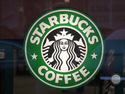 FILE - The Starbucks sign is displayed in the window of a Pittsburgh Starbucks, Jan. 30, 2023. On Monday, June 12, jurors in a federal court in New Jersey awarded $25.6 million to a former regional Starbucks manager who alleged that she and other white employees were unfairly punished by the coffee chain after the high-profile 2018 arrests of two Black men at one of the chain's Philadelphia locations. (AP Photo/Gene J. Puskar, File)
