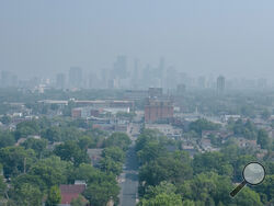 The Minneapolis skyline, seen from the Powderhorn Park, is obscured by wildfire smoke during the air quality alert on Wednesday, June 28, 2023, in Minneapolis. (Kerem Yücel/Minnesota Public Radio via AP)