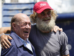 Australian Timothy Lyndsay Shaddock, right, poses for photos with Grupo Mar President Antonio Suarez during a welcoming ceremony after being rescued from sea and arriving to port in Manzanillo, Mexico, Tuesday, July 18, 2023. After being adrift with his dog for three months, Shaddock and his dog were rescued by the crew of the tuna boat owned by Grupo Mar from an incapacitated catamaran in the Pacific Ocean some 1,200 miles from land. (AP Photo/Fernando Llano)