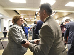 Mayor Jerry Morales speaks with Texas A&M President Katherine Banks after an announcement about the Texas A&M-Concho Engineering Academy, Feb. 14, 2019, in the Carrasco Room at Midland College. Texas A&M University announced Friday, July 21, 2023, that Banks has resigned after a Black journalist's celebrated hiring at one of the nation's largest campuses unraveled following pushback over her diversity and inclusion work.(James Durbin/Reporter-Telegram via AP)