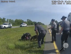 This image taken from police body cam video shows a police dog attacking Jadarrius Rose, 23, of Memphis, Tennessee on Tuesday, July 4, 2023, in Circleville, Ohio. An investigation has been launched into why an Ohio officer allowed his police dog to attack a truck driver who was surrendering with his hands raised, despite State Highway Patrol troopers urging the officer to hold the dog back. (Ohio State Highway Patrol via AP)