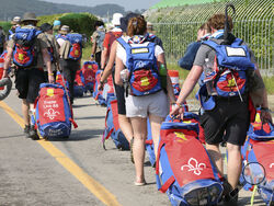 British scout members leave the World Scout Jamboree campsite in Buan, South Korea, Sunday, Aug. 6, 2023. South Korea is preparing to evacuate tens of thousands of scouts from a coastal jamboree site as Tropical Storm Khanun looms, world scouting officials said Monday. (Choe Young-soo/Yonhap via AP)