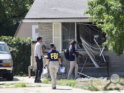 Law enforcement investigate the scene of a shooting involving the FBI Wednesday, Aug. 9, 2023 in Provo, Utah. A man accused of making threats against President Joe Biden was shot and killed by FBI agents hours before the president was expected to land in the state Wednesday, authorities said. (Laura Seitz/The Deseret News via AP)