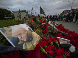 AP Photo/Dmitri Lovetsky A portrait of the owner of private military company Wagner Group Yevgeny Prigozhin lays at an informal memorial next to the former 'PMC Wagner Centre' in St. Petersburg, Russia, Thursday.