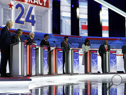 FILE - Republican presidential candidates, from left, former Arkansas Gov. Asa Hutchinson, former New Jersey Gov. Chris Christie, former Vice President Mike Pence, Florida Gov. Ron DeSantis, businessman Vivek Ramaswamy, former U.N. Ambassador Nikki Haley, Sen. Tim Scott, R-S.C., and North Dakota Gov. Doug Burgum stand on stage and listen to a prayer before a Republican presidential primary debate hosted by FOX News Channel, Wednesday, Aug. 23, 2023, in Milwaukee. (AP Photo/Morry Gash, File)