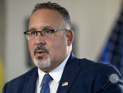 FILE - Education Secretary Miguel Cardona speaks during an interview with The Associated Press in his office at the Department of Education, Sept. 20, 2023, in Washington. The Biden administration is asking America's colleges to renew their efforts to make campuses more racially diverse, urging schools to boost scholarships and minority recruiting and to give “meaningful consideration” to the adversity students face because of their race or finances. (AP Photo/Mark Schiefelbein, File)