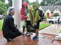 The Rev. Joseph Strickland, left, bishop of the Diocese of Tyler, goes to one knee Wednesday, Aug. 17, 2016, to greet children on the first day of school at St. Gregory Cathedral School in Tyler, Texas. Pope Francis on Saturday, Nov. 11, 2023, forcibly removed Strickland, a firebrand conservative prelate active on social media who has been a fierce critic of the pontiff and has come to symbolize the polarization within the U.S. Catholic hierarchy. (Andrew D. Brosig/Tyler Morning Telegraph via AP)