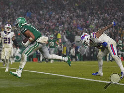 Philadelphia Eagles quarterback Jalen Hurts scores the game winning touchdown against the Buffalo Bills during overtime in an NFL football game Sunday, Nov. 26, 2023, in Philadelphia. (AP Photo/Matt Slocum)